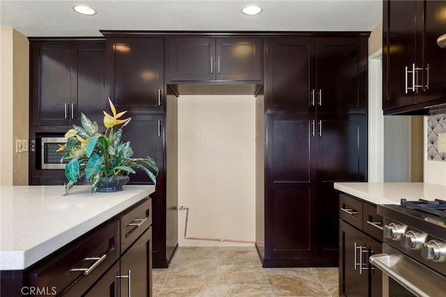 kitchen with recessed lighting, dark brown cabinetry, appliances with stainless steel finishes, and light countertops