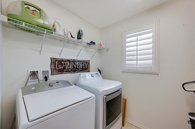 laundry area featuring laundry area, baseboards, and washing machine and clothes dryer