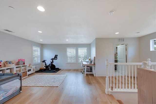 exercise room with recessed lighting, visible vents, and wood finished floors