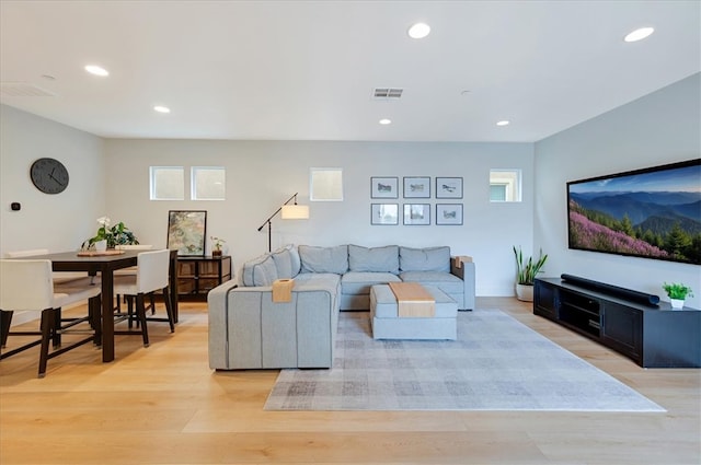 living room with light wood-style flooring, recessed lighting, and visible vents