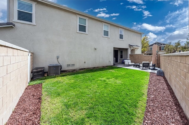 back of house featuring a patio, central AC unit, a fenced backyard, stucco siding, and a lawn