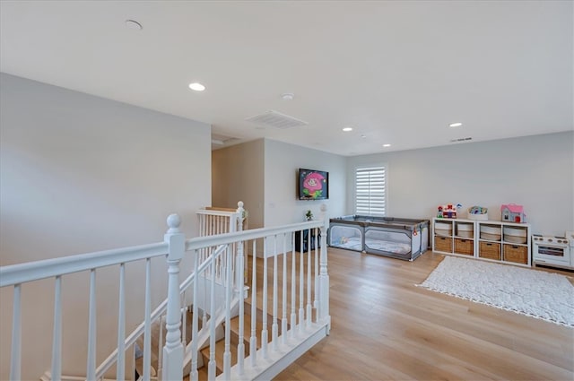 bedroom with recessed lighting, wood finished floors, and visible vents