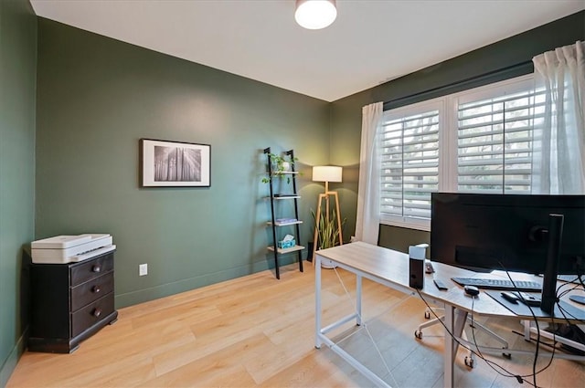 home office featuring light wood-style flooring and baseboards