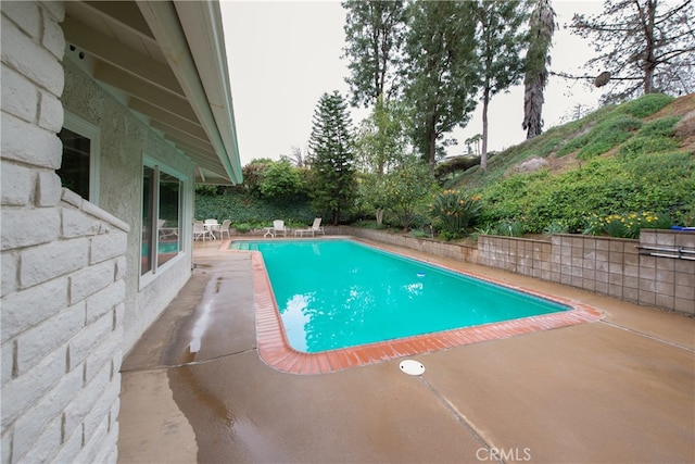 view of pool featuring a patio area and a fenced in pool