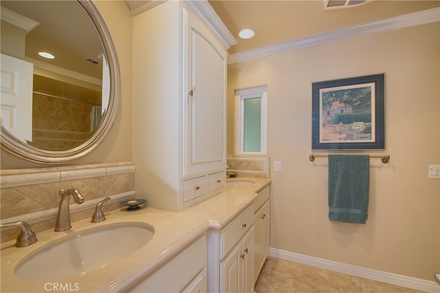 bathroom with a sink, baseboards, double vanity, and crown molding