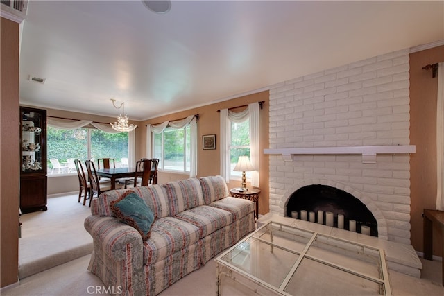 carpeted living room featuring a brick fireplace, visible vents, and a chandelier