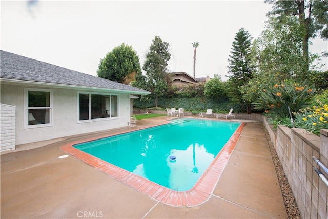 view of swimming pool featuring a patio area and a fenced in pool