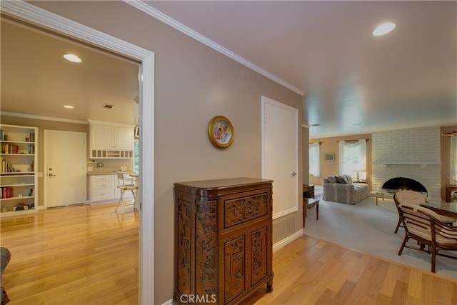 hall with recessed lighting, light wood-style flooring, and ornamental molding