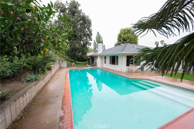 view of pool with a patio area, a fenced in pool, and fence