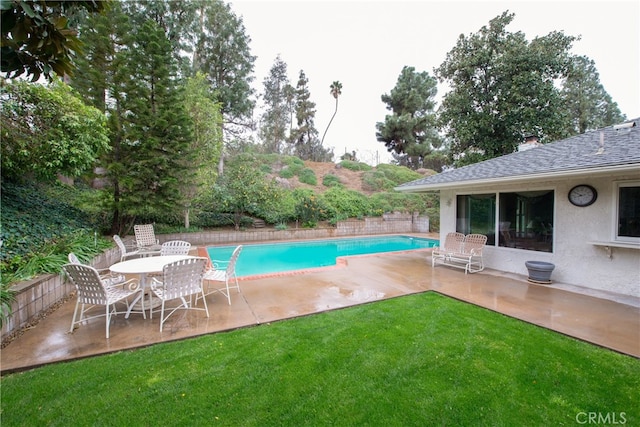 view of pool with a fenced in pool, a yard, a patio area, and fence