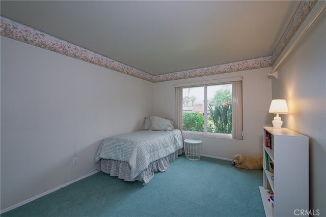 bedroom with baseboards and carpet