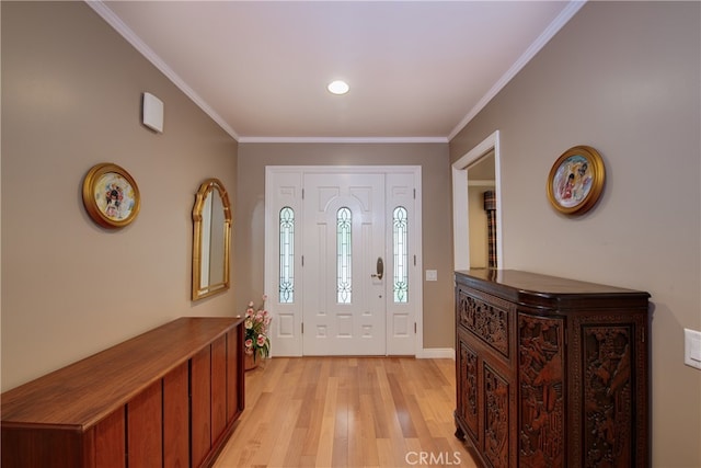 foyer featuring light wood-style floors and ornamental molding