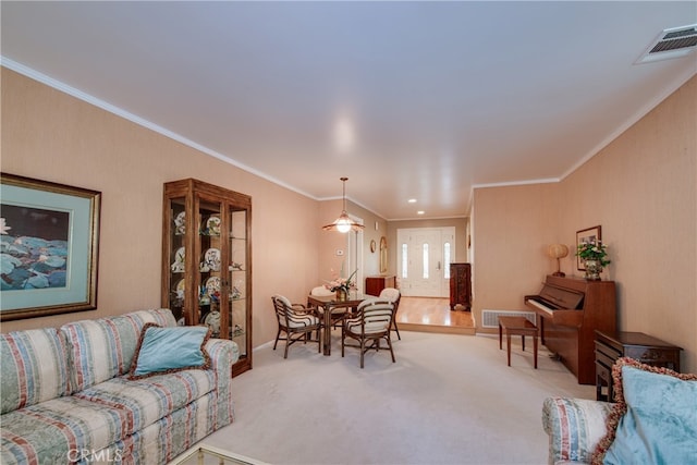 living room featuring light carpet, visible vents, and ornamental molding