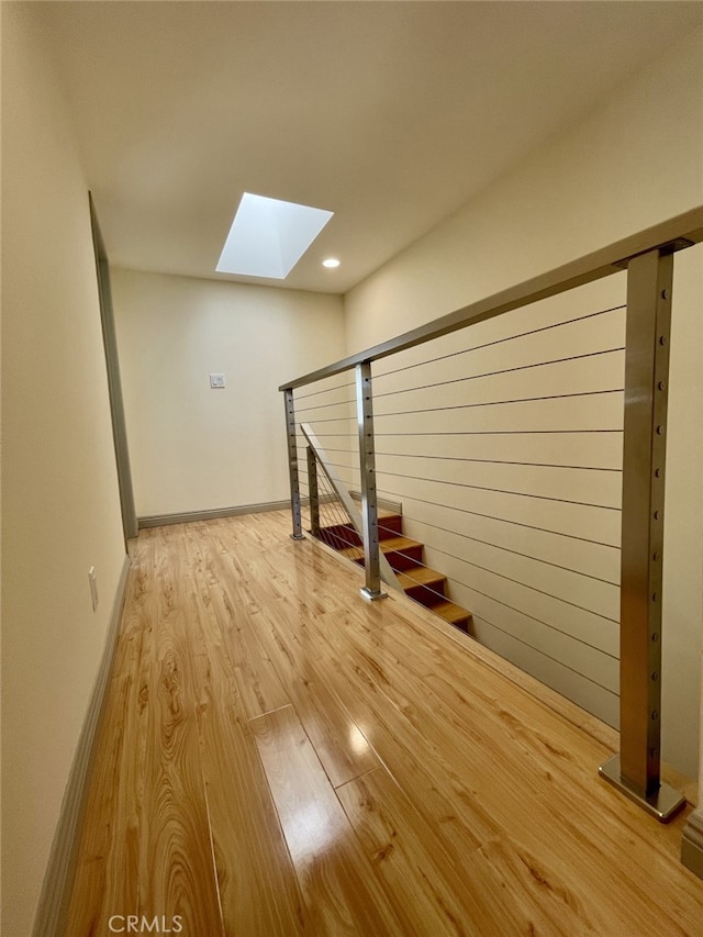 below grade area with baseboards and wood finished floors