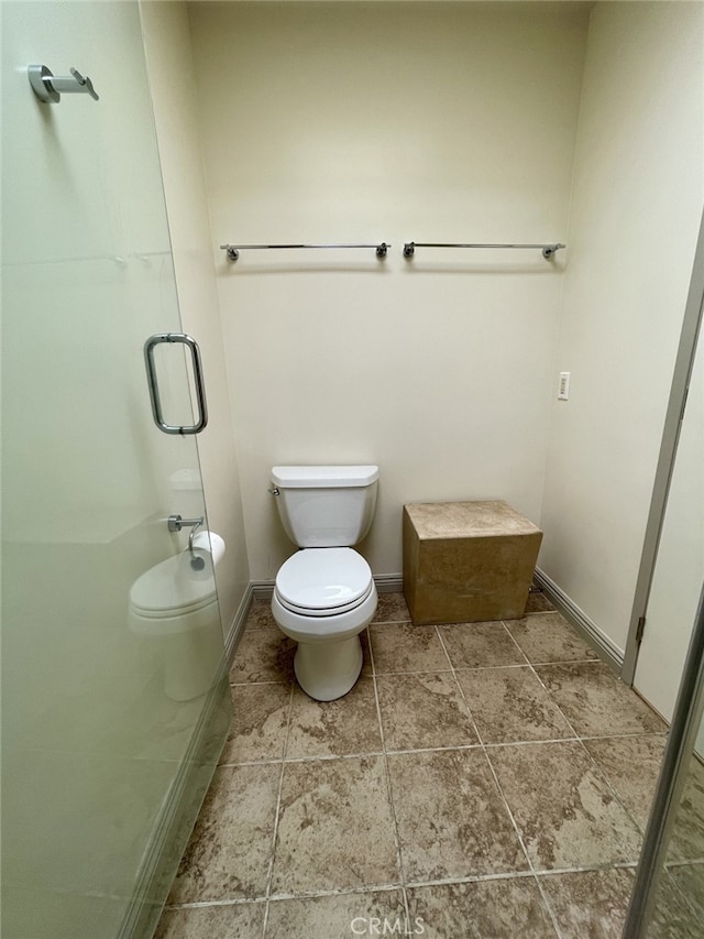 full bathroom with tile patterned floors, a stall shower, toilet, and baseboards