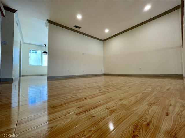 unfurnished room with visible vents, light wood-style flooring, recessed lighting, crown molding, and baseboards