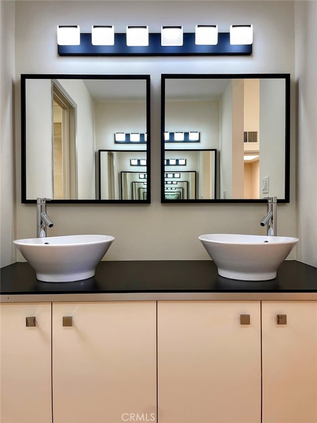 bathroom featuring double vanity and a sink