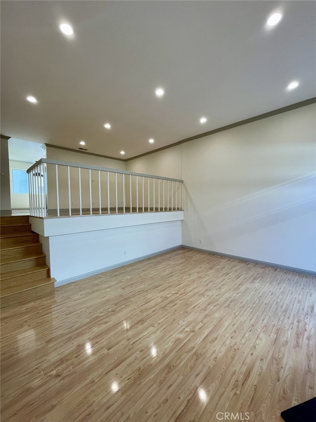 spare room featuring recessed lighting, ornamental molding, and wood finished floors