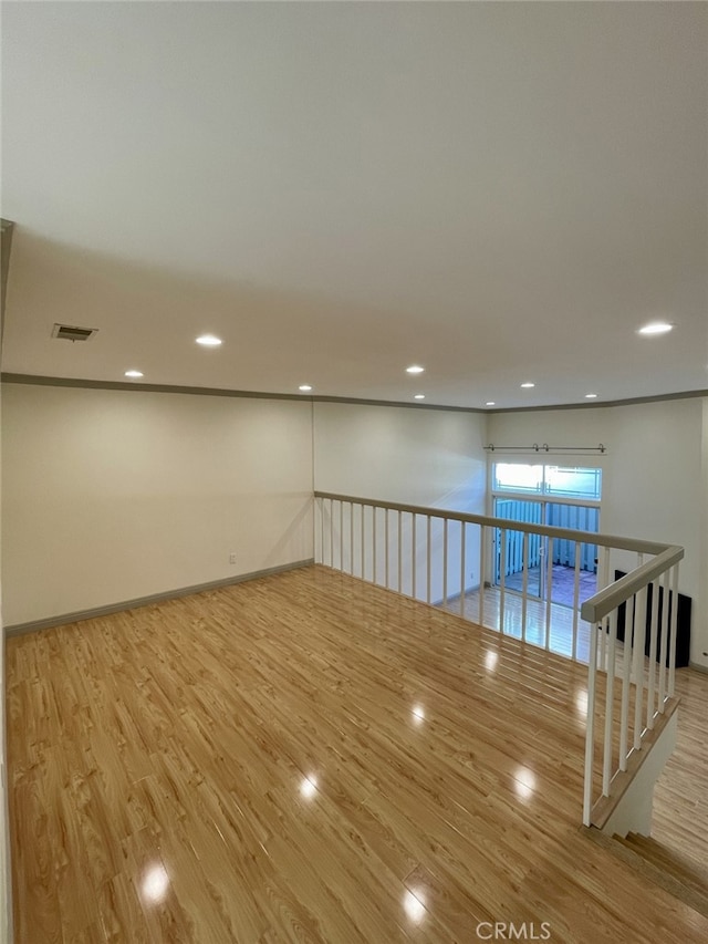 spare room with recessed lighting, wood finished floors, and visible vents