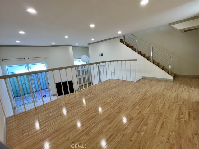 spare room featuring visible vents, recessed lighting, crown molding, and wood finished floors