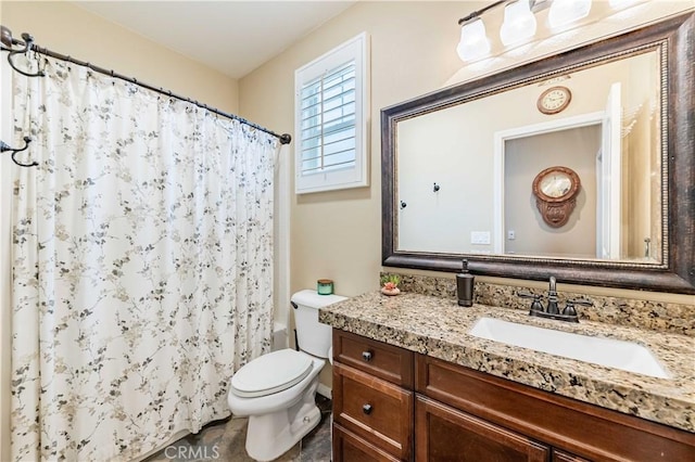 bathroom with a shower with shower curtain, toilet, and vanity