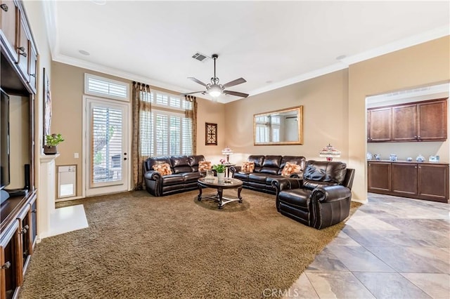 living room with light carpet, a ceiling fan, visible vents, and ornamental molding