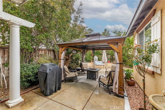 view of patio / terrace with a gazebo, grilling area, a fire pit, and fence