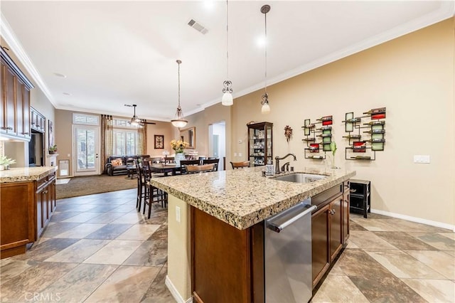 kitchen with a center island with sink, visible vents, a sink, stainless steel dishwasher, and crown molding