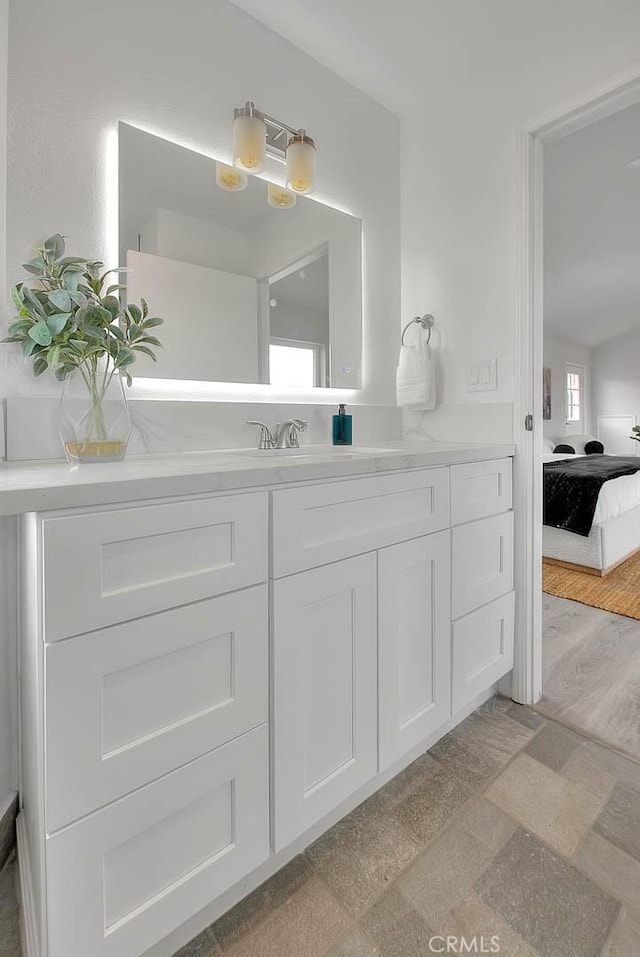 ensuite bathroom with vanity and ensuite bath