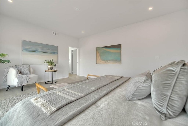 bedroom with wood finished floors, recessed lighting, baseboards, and visible vents