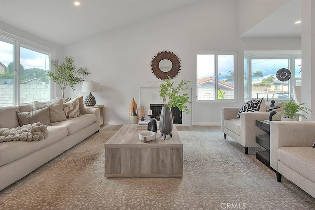 living area featuring recessed lighting, high vaulted ceiling, and baseboards