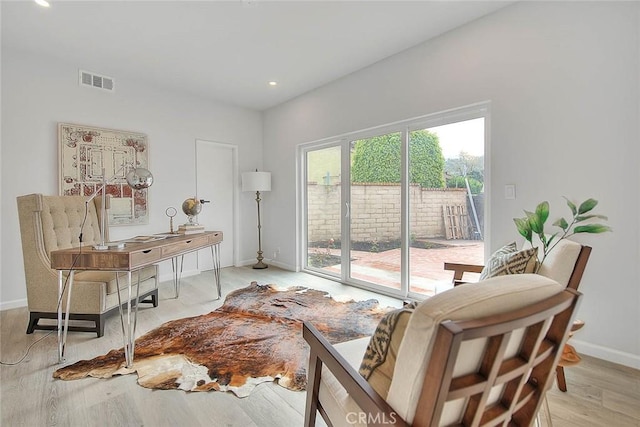 home office with baseboards, visible vents, and light wood finished floors