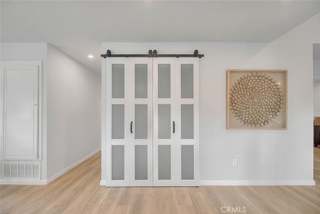 interior space with visible vents, baseboards, and wood finished floors