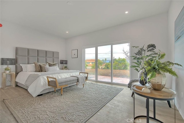 bedroom with access to outside, recessed lighting, and light wood-style floors