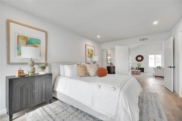 bedroom featuring light wood-style flooring, recessed lighting, and visible vents