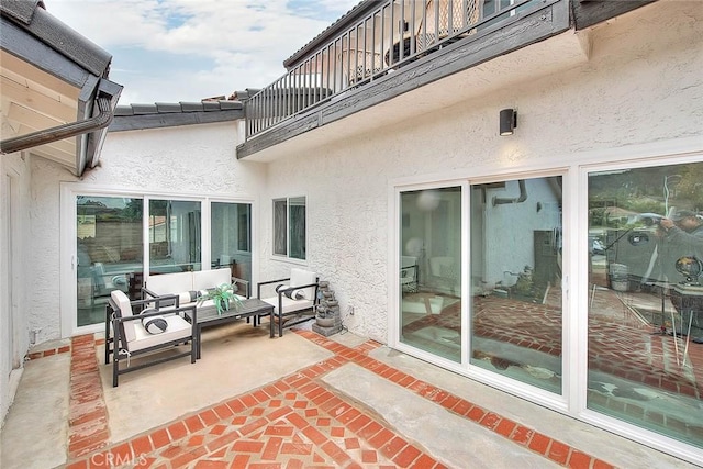 view of patio / terrace with an outdoor living space and a balcony