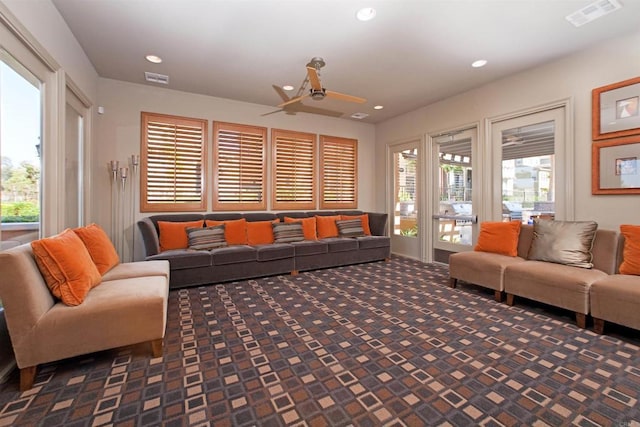 carpeted living room with a ceiling fan, recessed lighting, and visible vents