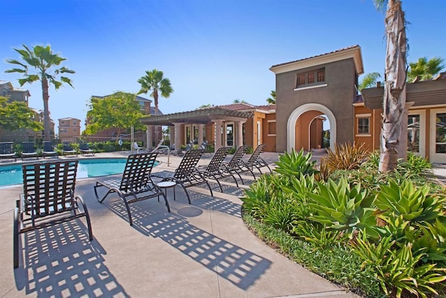 pool with a pergola, a patio, and fence