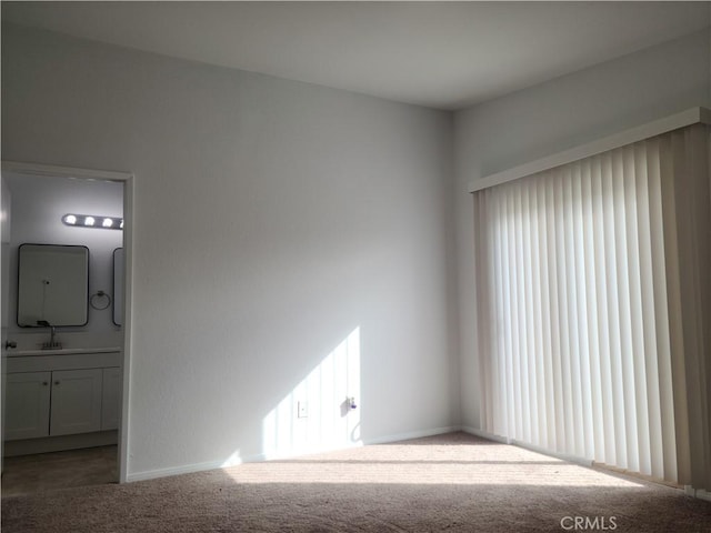 empty room with baseboards and carpet