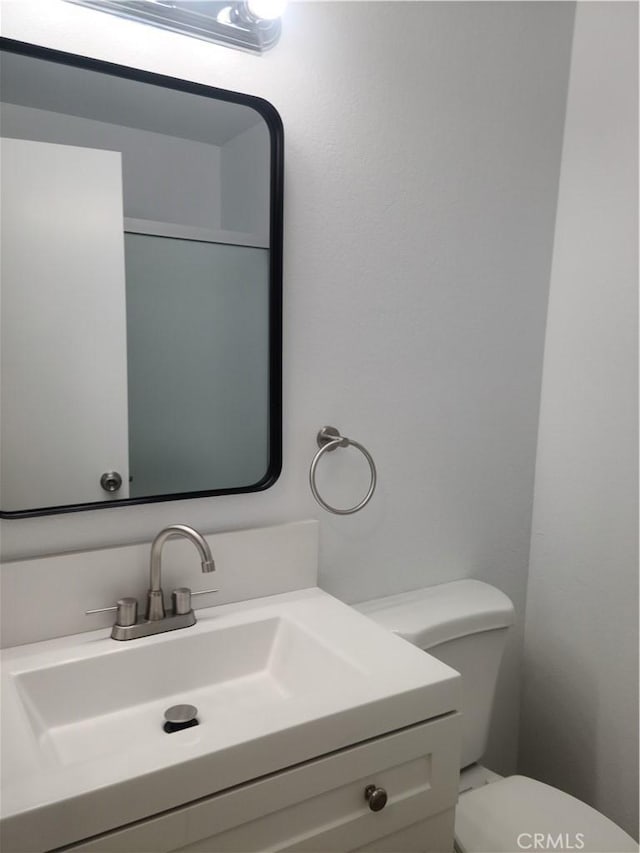 bathroom featuring toilet and vanity