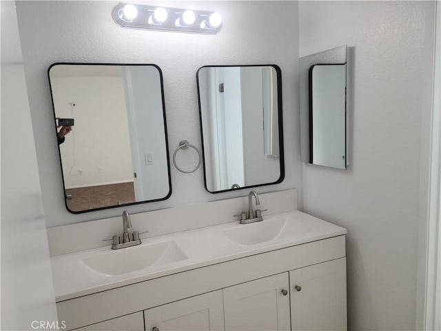 bathroom with a sink and double vanity