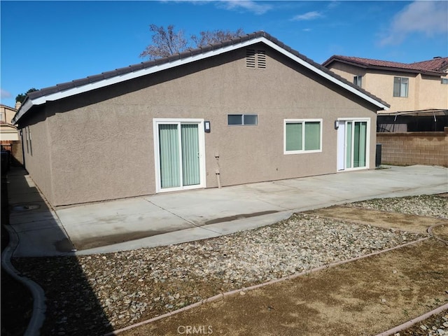 back of property with a patio area, fence, and stucco siding