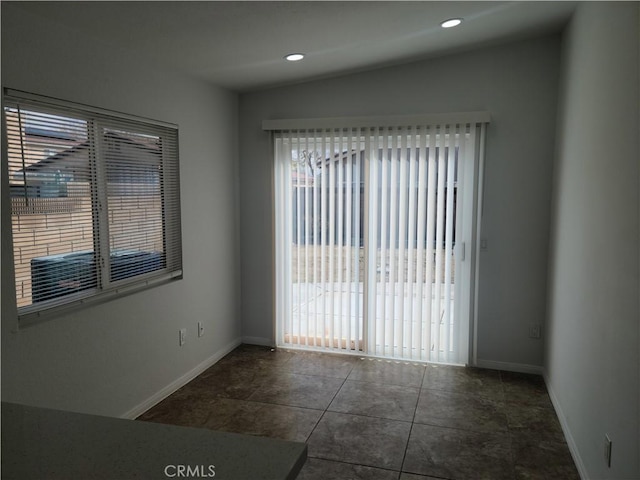 empty room featuring recessed lighting and baseboards