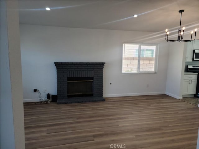 unfurnished living room with baseboards, dark wood-style floors, and a fireplace