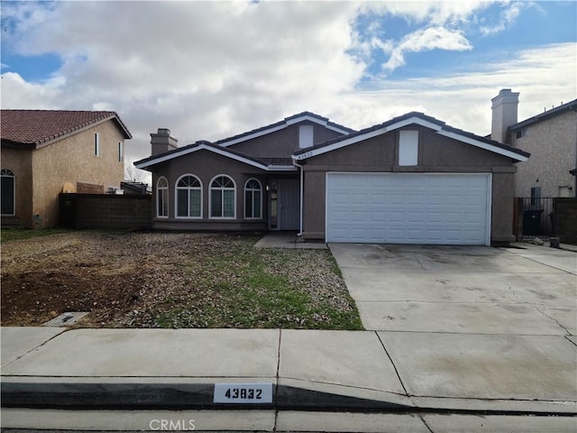 view of front of property with fence, driveway, an attached garage, a chimney, and stucco siding