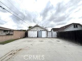 detached garage featuring fence