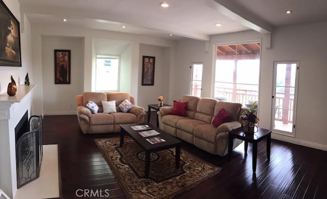 living area featuring recessed lighting, beamed ceiling, baseboards, and dark wood-type flooring