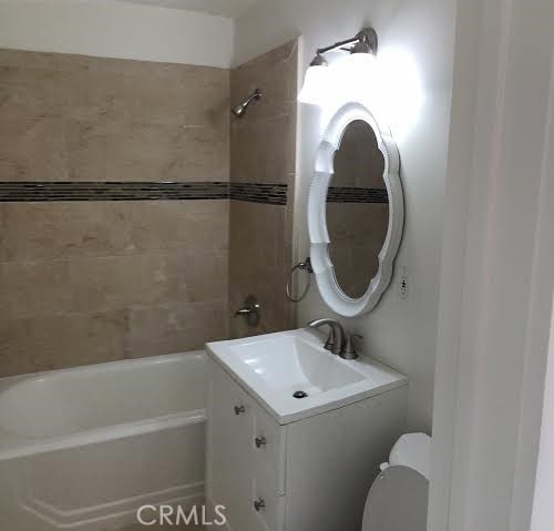 full bathroom featuring vanity, toilet, and shower / bathtub combination