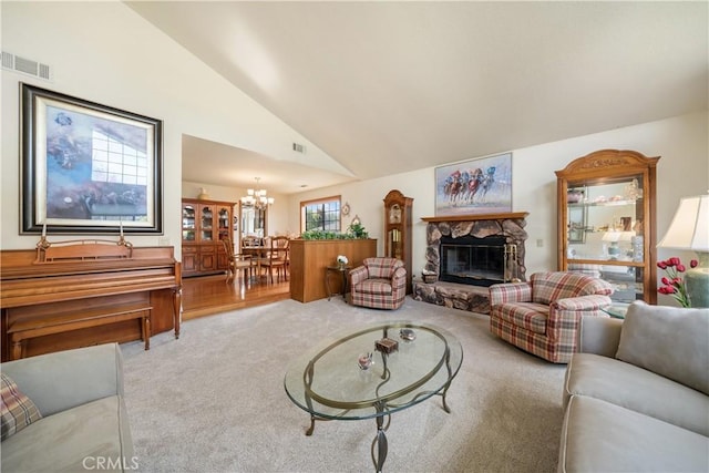 living area featuring visible vents, carpet floors, a stone fireplace, and a chandelier