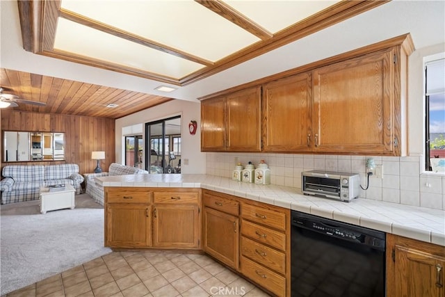 kitchen featuring tasteful backsplash, open floor plan, a toaster, light colored carpet, and dishwasher